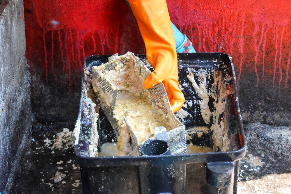 Grease,Traps,From,Dirty,Debris,Being,Cleaned,With,A,Scoop