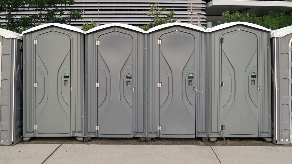 Several,Gray,Port,O,Potties,Lined,Up,Outside.